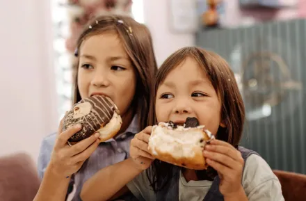 kids eating doughnuts on a walking food tour in Seattle