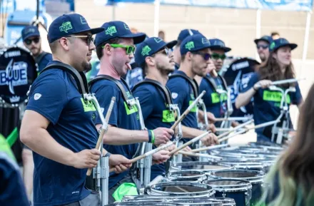 drumline wearing Seattle Seahawks football jerseys in a parade