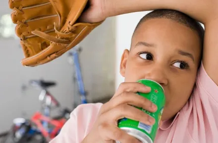 boy drinking from a can