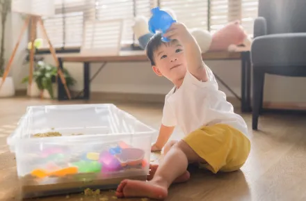 child playing in sand sensory bin