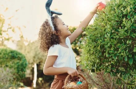 girl finding an Easter egg outside