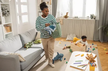 mom and kids picking up toys