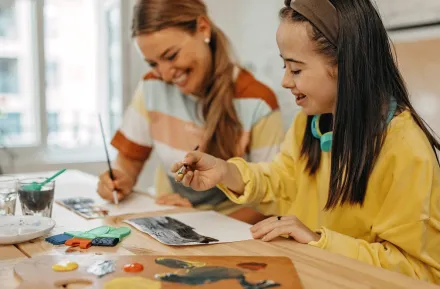 young girl painting during a sensory-friendly outing in Seattle