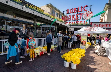 families enjoying Daffodil Day at Pike Place Market in Seattle on a spring weekend