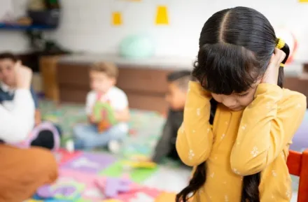 preschool girl frustrated covering her ears