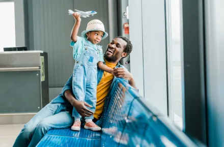 dad at an airport with his son