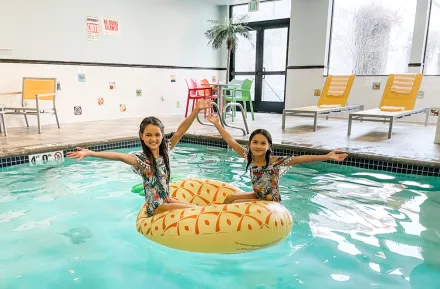 two happy girls at a pool at Maxwell Hotel