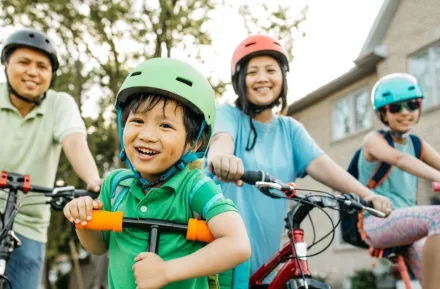 family biking outside in summers