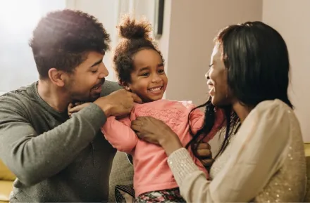 married couple and child in living room