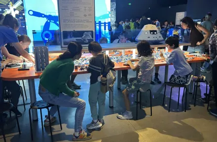 families building with Lego bricks at the 'Artemis Adventure with Lego Bricks'