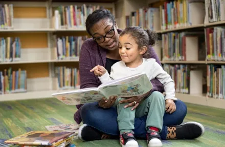 parent and child reading at library