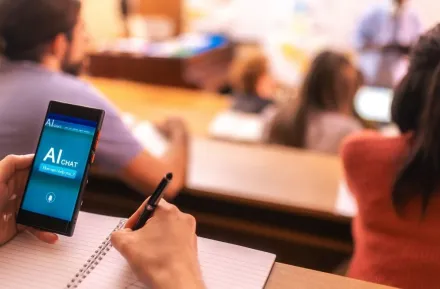 Student using AI app on mobile phone in classroom