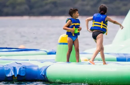 Children playing on inflatable floating water park