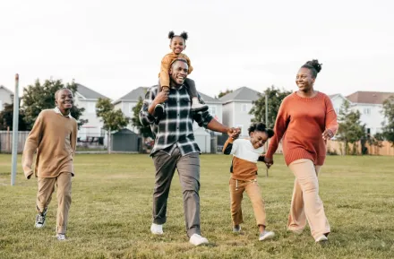 A happy African American family hold hands as they celebrate Juneteenth.