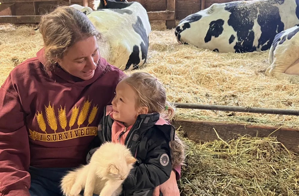 Grandma Lori with Evangeline with the cows in the maternity area