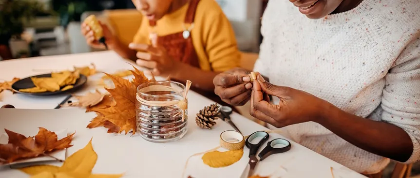 Mom and kid doing fall crafts for kids together