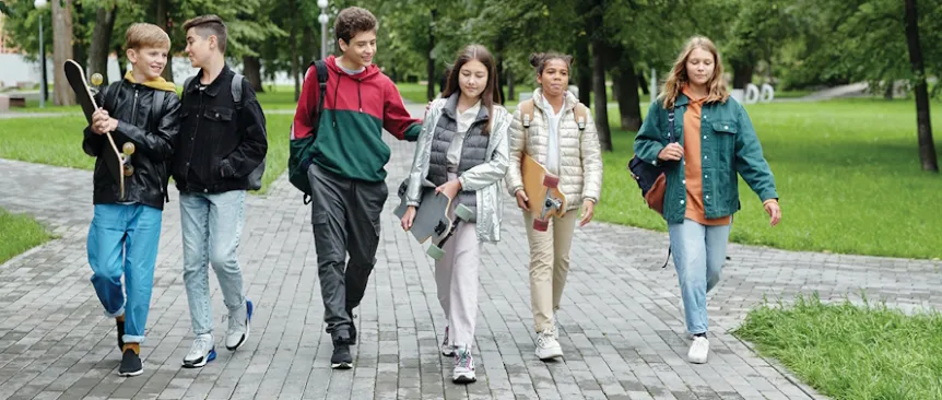 Group of teen kids walking down the street together 