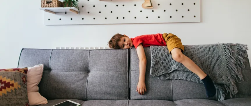 unmotivated child on the back of a couch