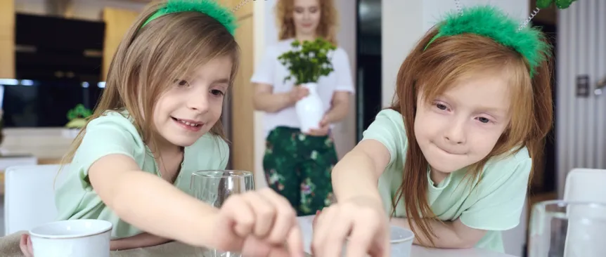 two girls reaching for a St. Patrick's Day treat