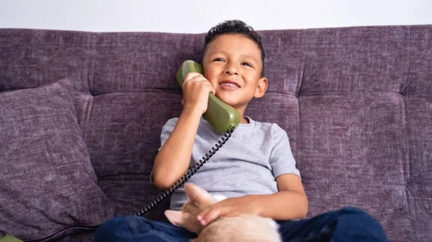 young boy on a landline phone