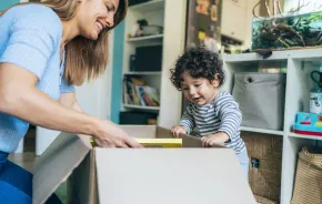 Mom and toddler opening box