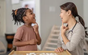Young girl having speech therapy