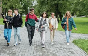 Group of teen kids walking down the street together 