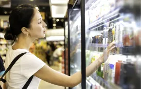 woman looking at cold drinks at a store