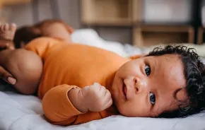 Little baby smiling at the camera