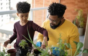 dad and son planting houseplants and connecting with nature