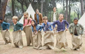 kids in a sack race at a summer camp