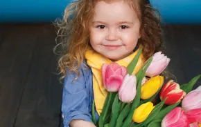 Young girl holding flowers May family activities Seattle
