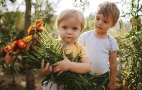 Two children holding flowers from a local Seattle-area flower farm