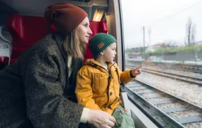 mom and child traveling on a train