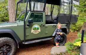 Keeper Adventure jeep with a little girl standing next to it