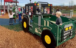 A child at a farm themed playground near Seattle on a sunny weekend
