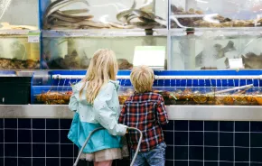 two kids looking at the fresh food for sale at T&T supermarket in Lynnwood