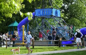 families on staycation in Redmond playing on the playground at Grass Lawn Park