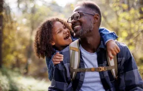 A boy and a dad hiking on a sunny day helps them connect and bond