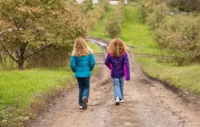 Two girls out for a walk on their own enjoying unsupervised play