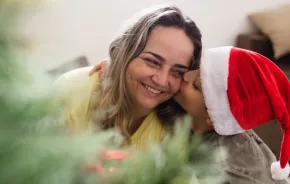 A boy hugs his mom on Christmas morning 