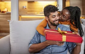 couple giving Valentine's Day gift smiling and happy
