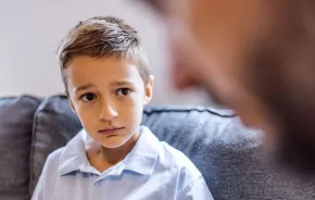 worried little boy talking to adult