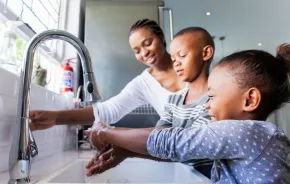 Family washing their hands together