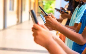 group of children hands busy using smartphone at school corridor