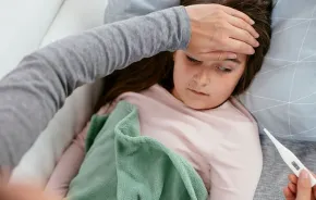 little girl sick checking body temperature with thermometer