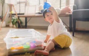 child playing in sand sensory bin
