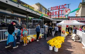 families enjoying Daffodil Day at Pike Place Market in Seattle on a spring weekend