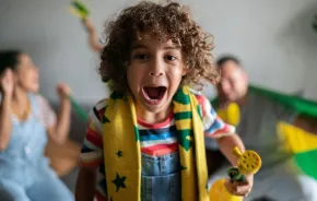 happy kid and family watching fifa