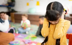 preschool girl frustrated covering her ears